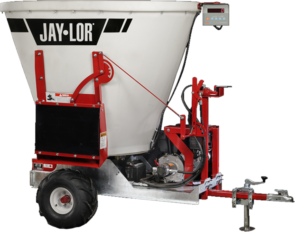 Jaylor 5050 TMR mixer and Carver trailer for mixing and processing livestock feed.